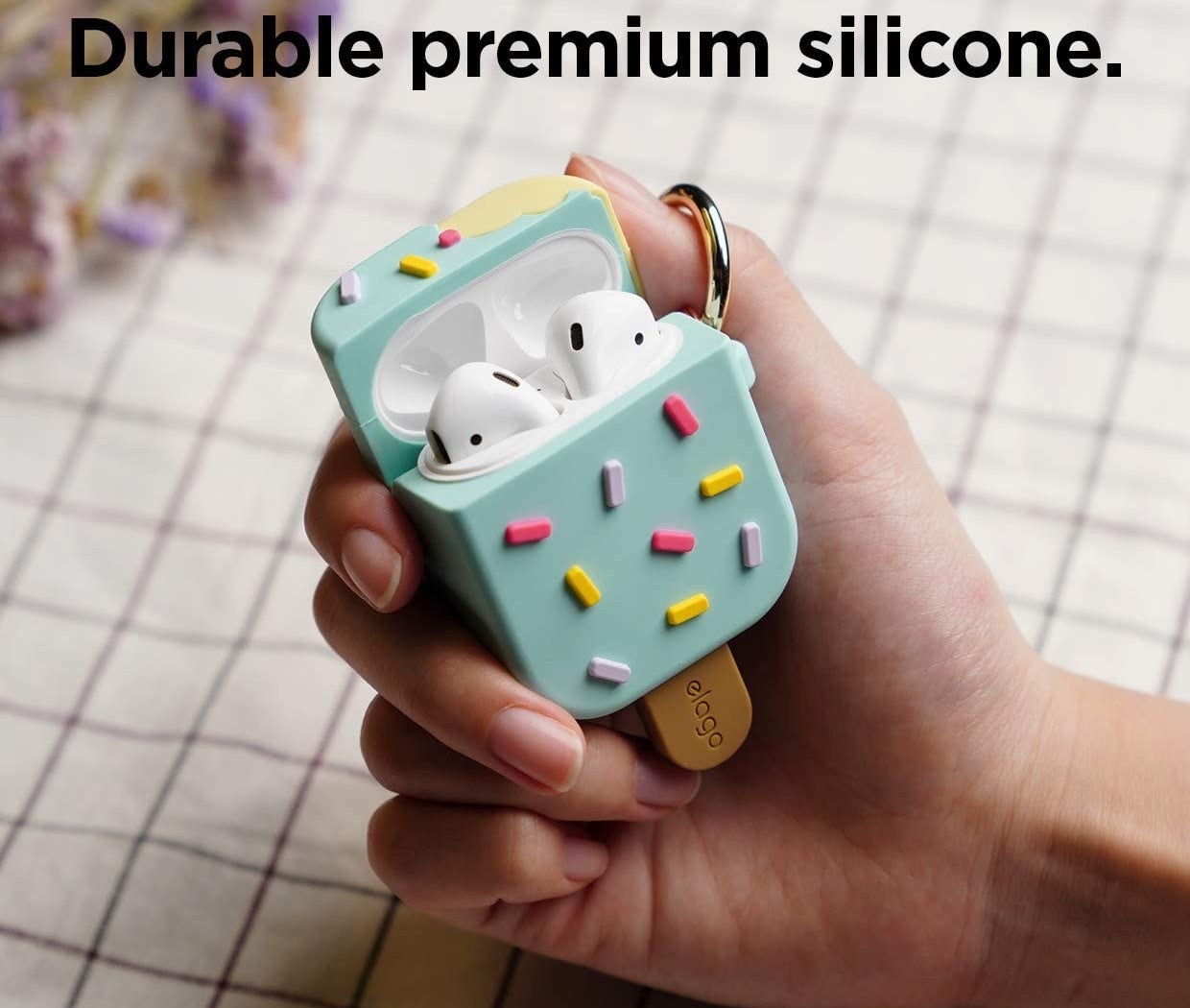 A person holding the icecream-shaped, silicone airpods case 