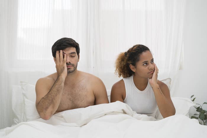 a couple having an argument in bed