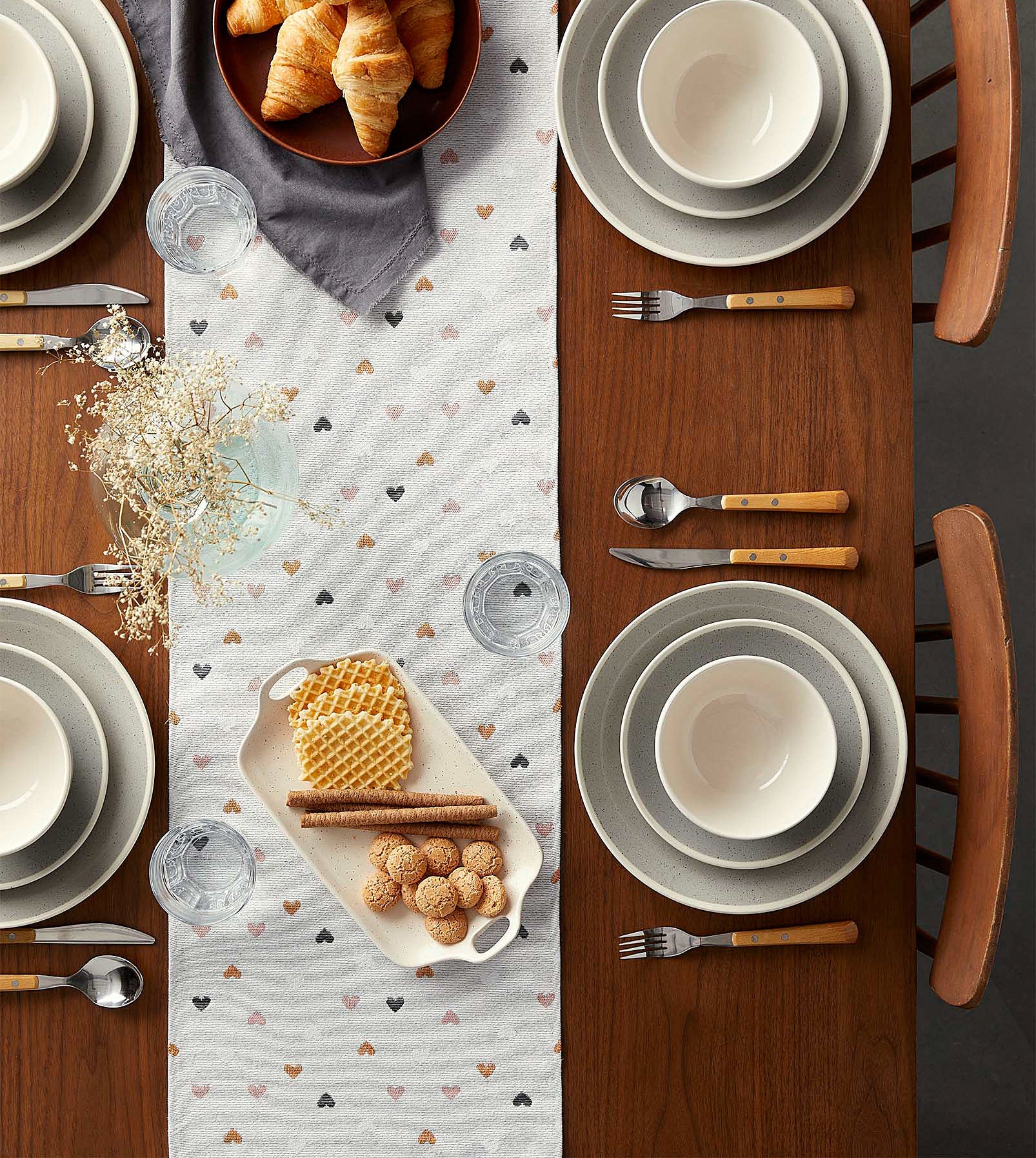 The table runner dotted with hearts laying flat on a table