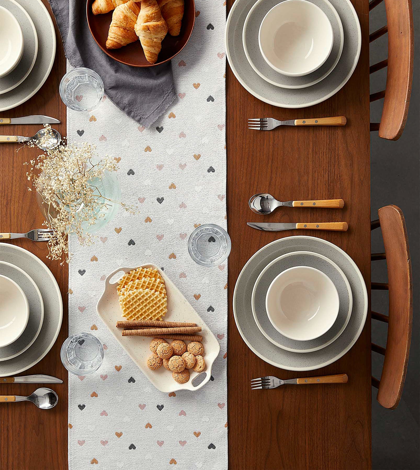 The table runner dotted with hearts laying flat on a table 