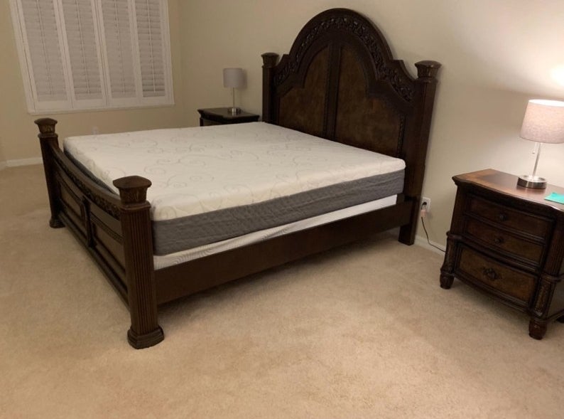 A king-sized mattress on a reviewer&#x27;s bed without sheets