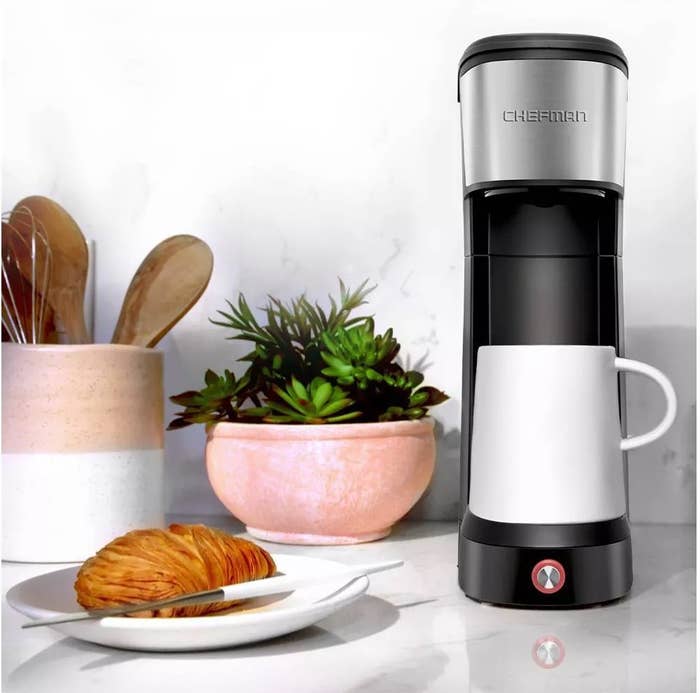The slim black and silver coffee maker on a kitchen counter