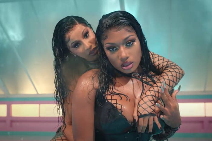 Cardi with her arm around Megan as they rock wet looks in the WAP music video