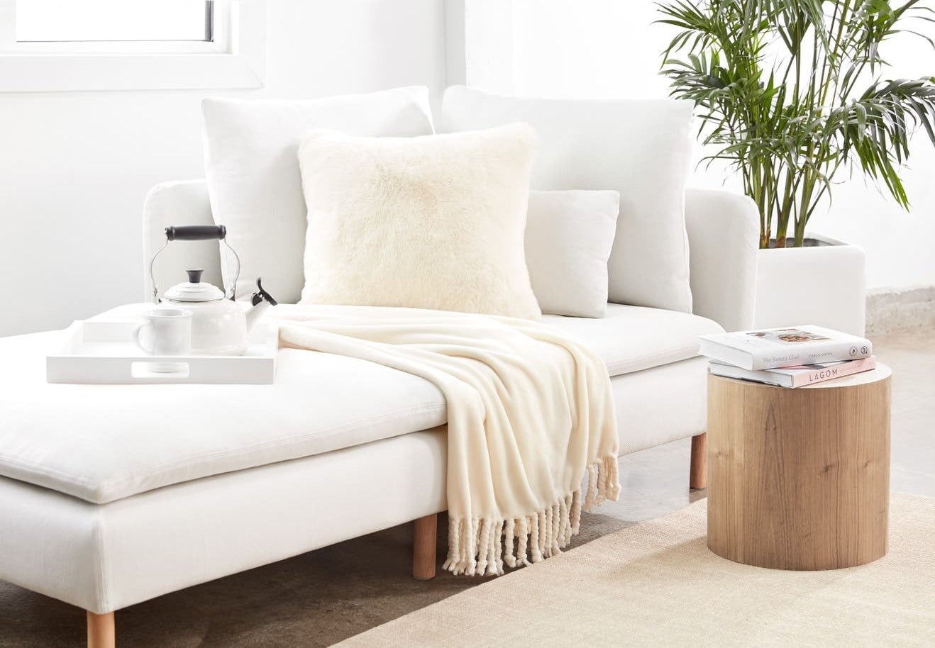 Cream plush blanket on a white couch