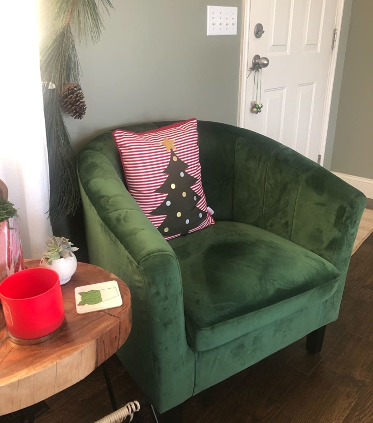 reviewer image of the emerald Modway Prospect Channel Tufted Upholstered Velvet Armchair with a christmas tree pillow on it