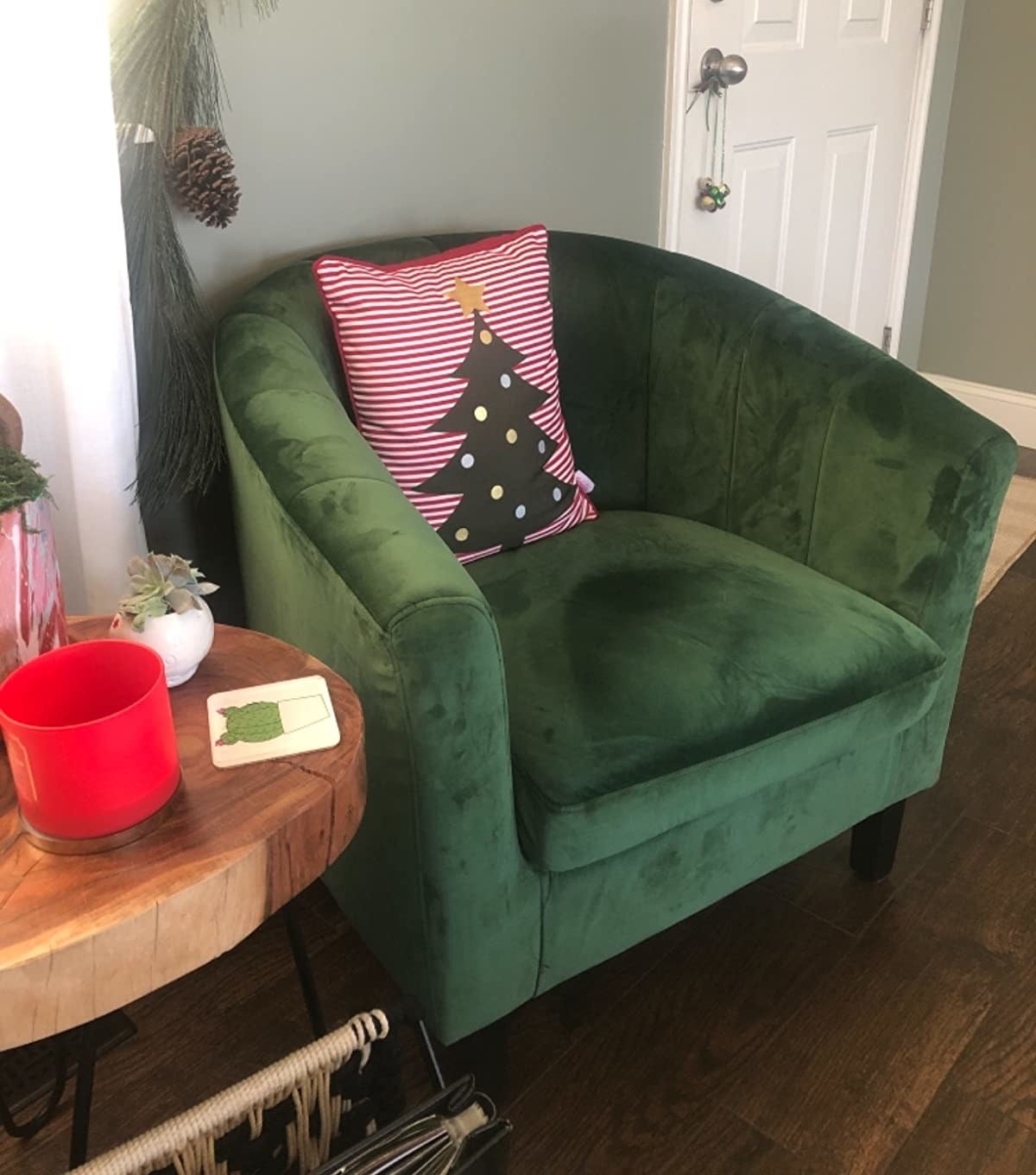 reviewer image of the emerald Modway Prospect Channel Tufted Upholstered Velvet Armchair with a christmas tree pillow on it