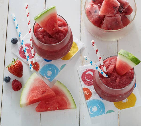 Sangria Watermelon Slush served in stemless wineglasses with slices of watermelon.