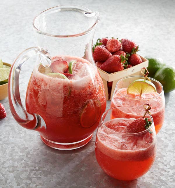Pitcher and glasses of Strawberry Lime Tequila Punch.