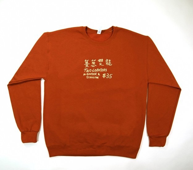 A crew neck sweatshirt printed with Chines script and text that reads &quot;Two Lobsters w. Ginger + Scallion $35&quot; 