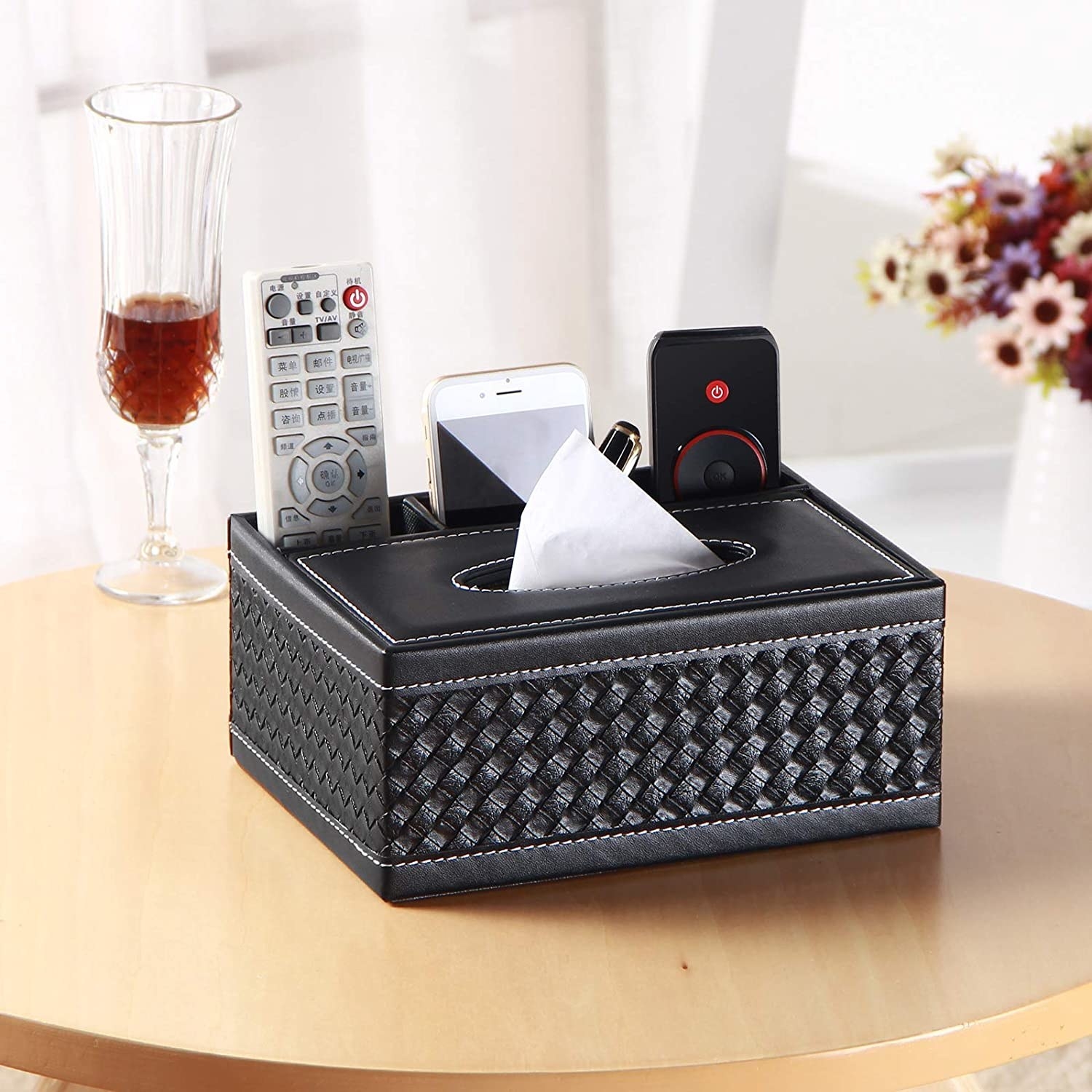 A faux leather tissue box cover with remote control caddies built in the back