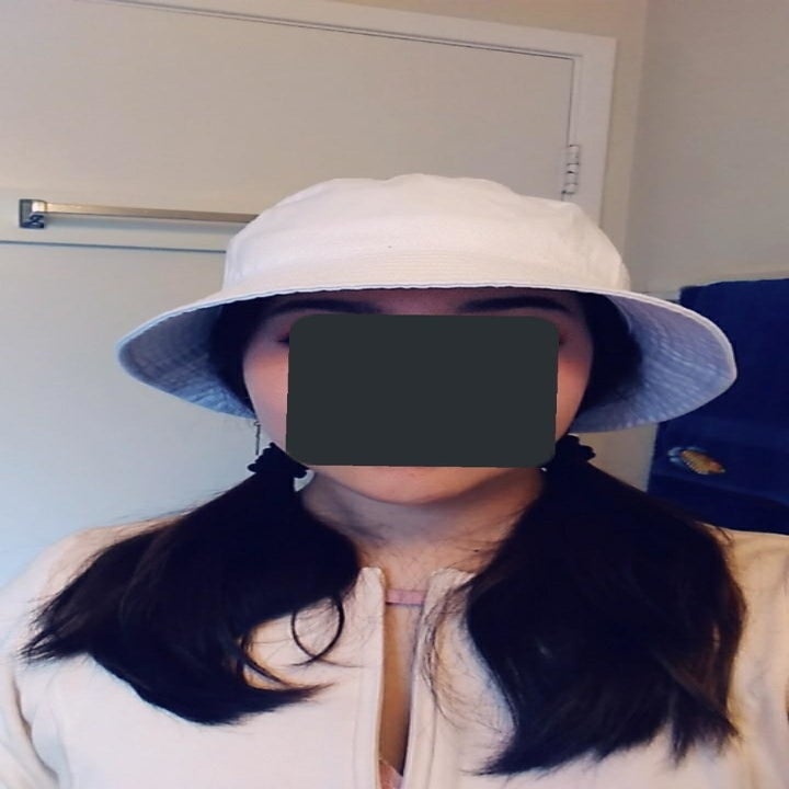 reviewer wearing hat in white 
