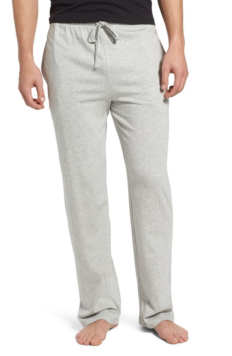 Model wears gray pajama pants with a black shirt