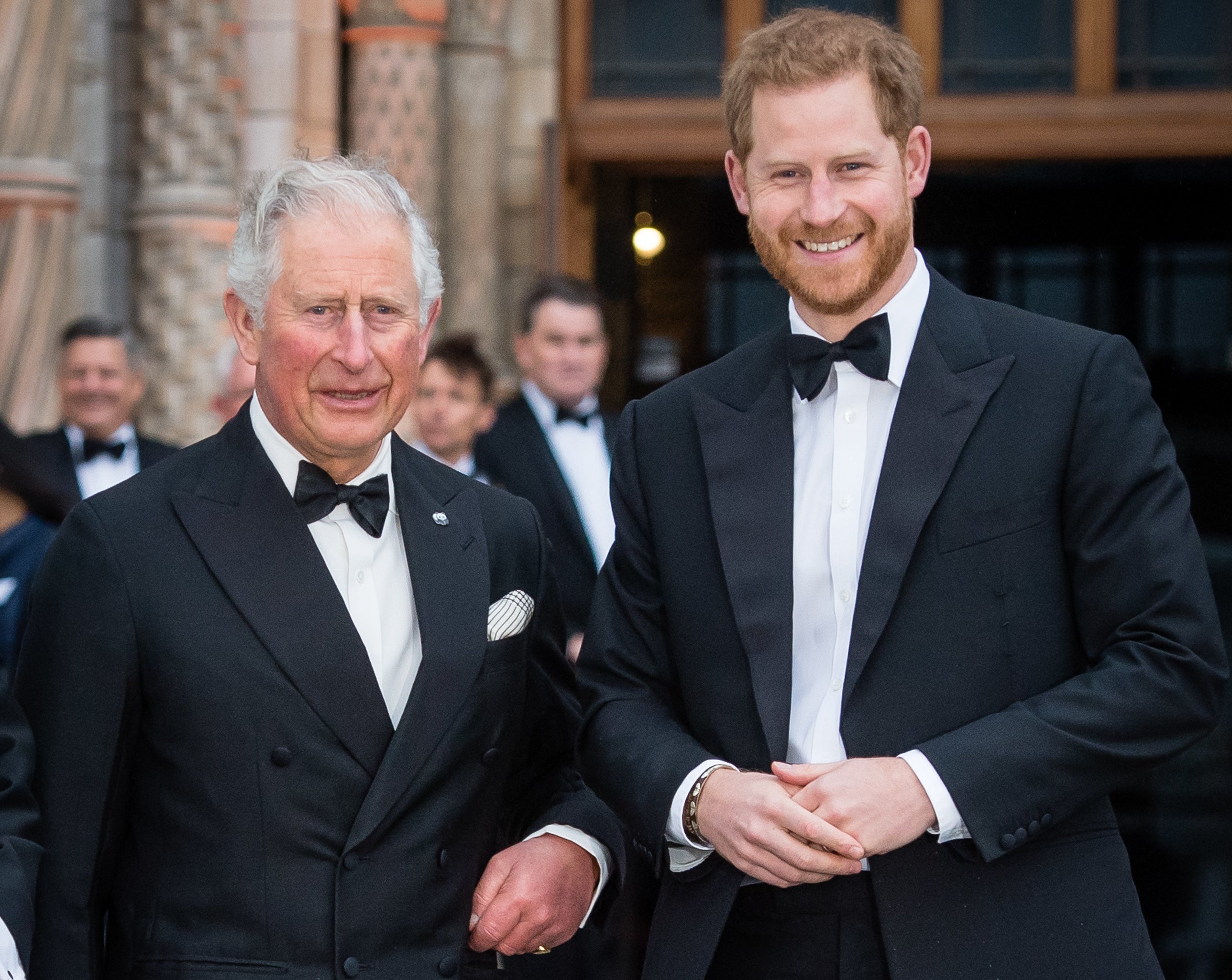 Harry stands next to his father, Prince Charles, during a black tie event