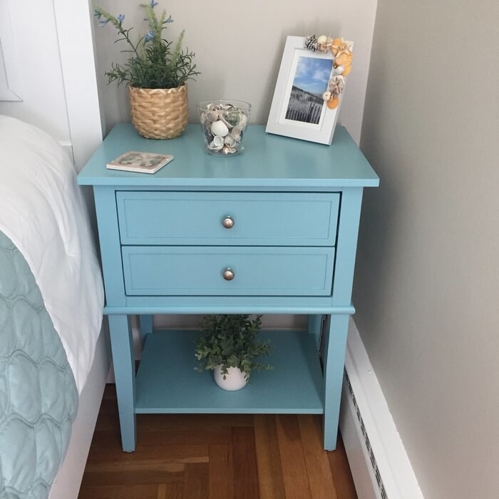 The table, which has two drawers and a platform for open storage