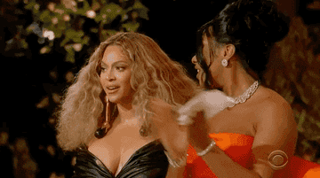 Beyonce fluffs her hair while looking surprised