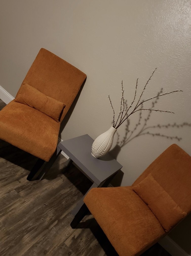 Reviewer&#x27;s image of end table sitting in-between two accent chairs