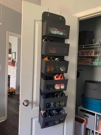 The over-the-door rack filled with shoes