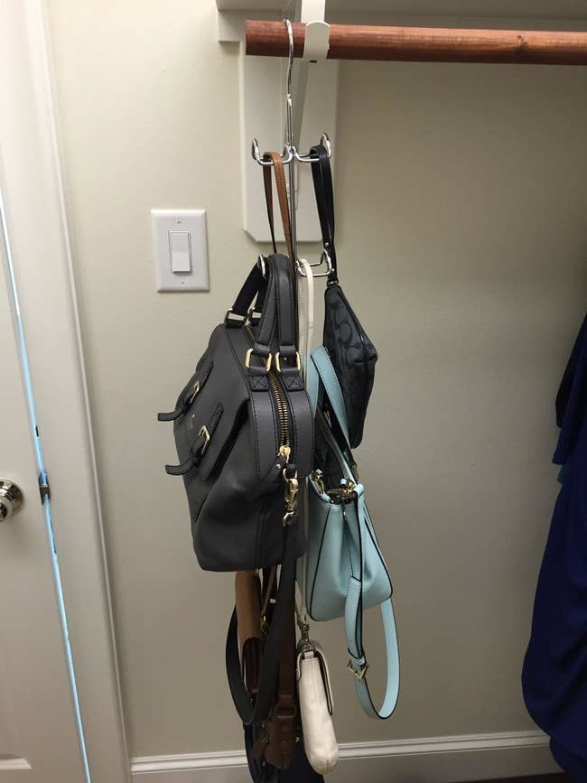 Reviewer photo of purses hanging from closet hook hanger