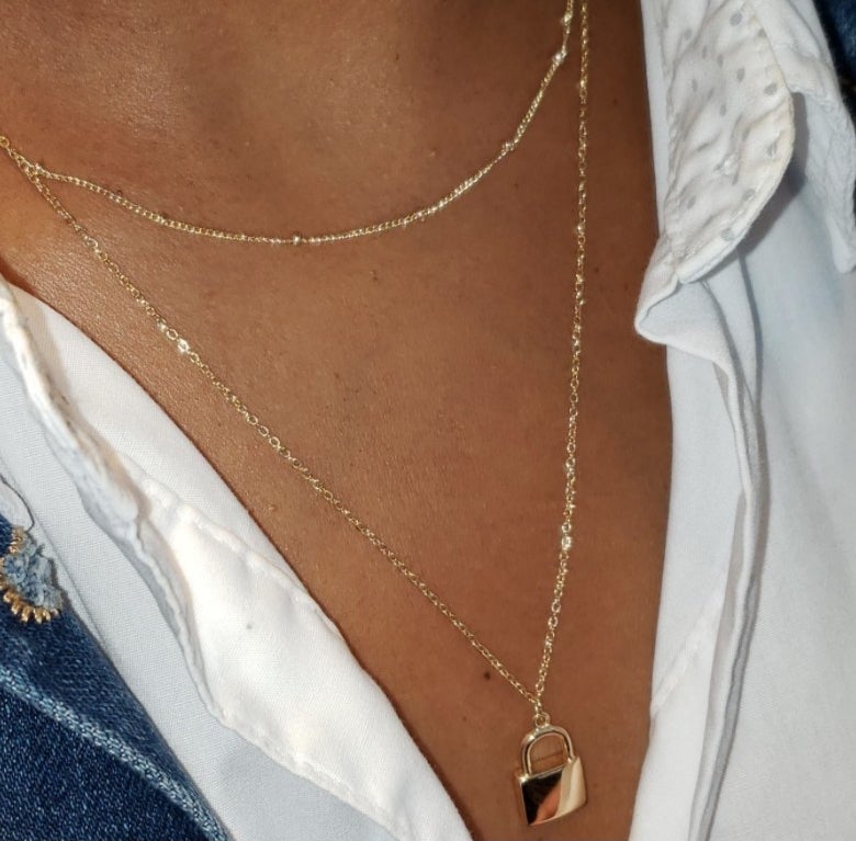 A reviewer wearing the lock necklace 