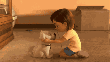 dog and child cuddle while on the floor in &quot;bolt&quot;