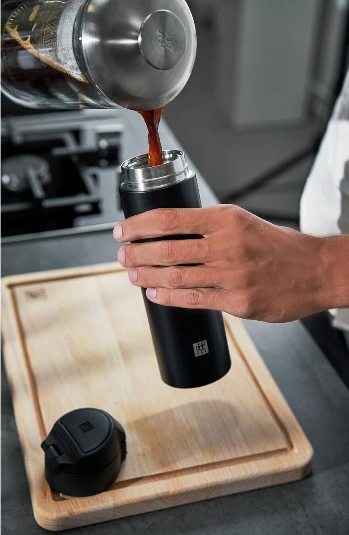 Model pouring coffee into thermos