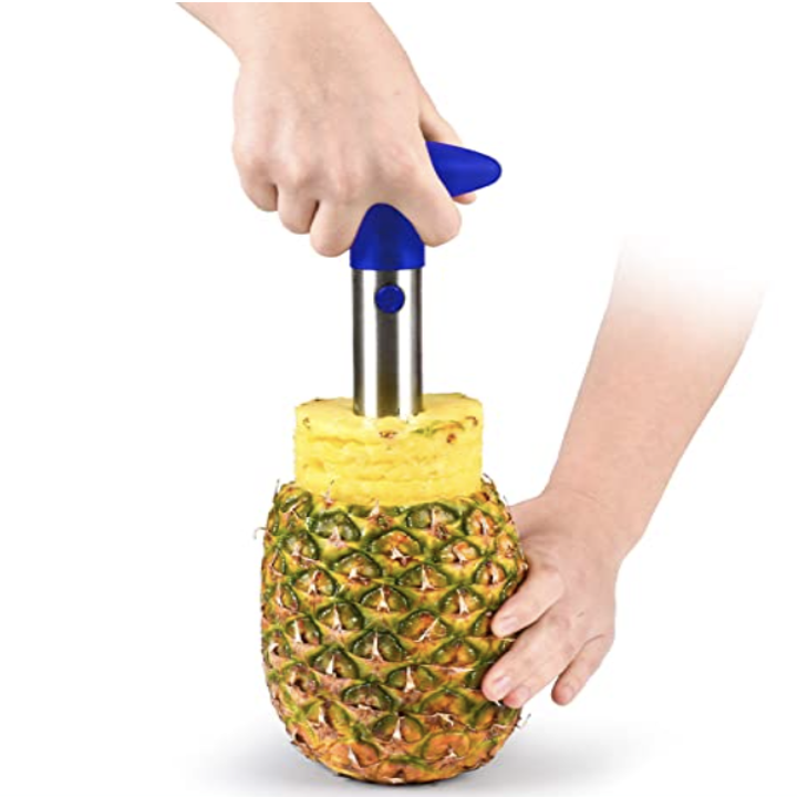 person using pineapple corer