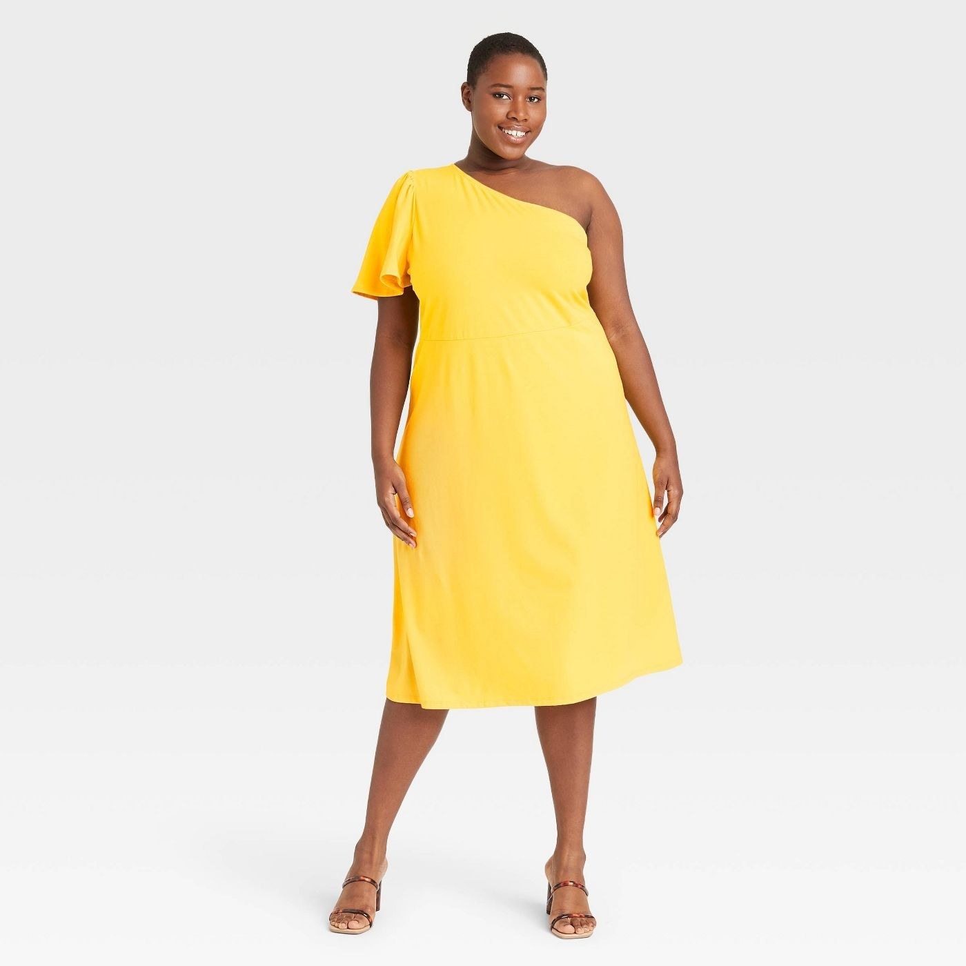 Model wearing yellow dress that goes past the knees