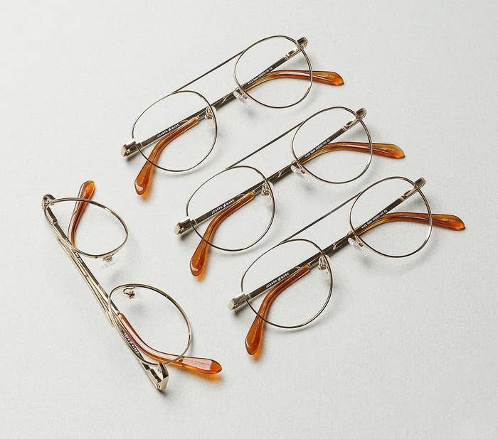 A flatlay of several pairs of wire-rimmed glasses