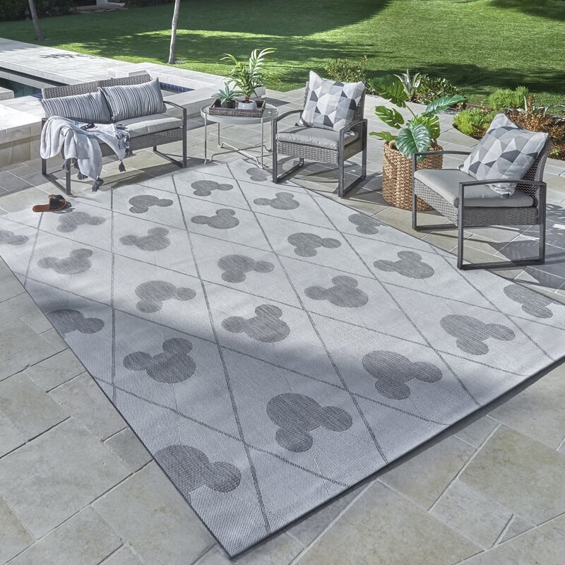 Gray rug with cross hatch pattern and gray Mickey icons 