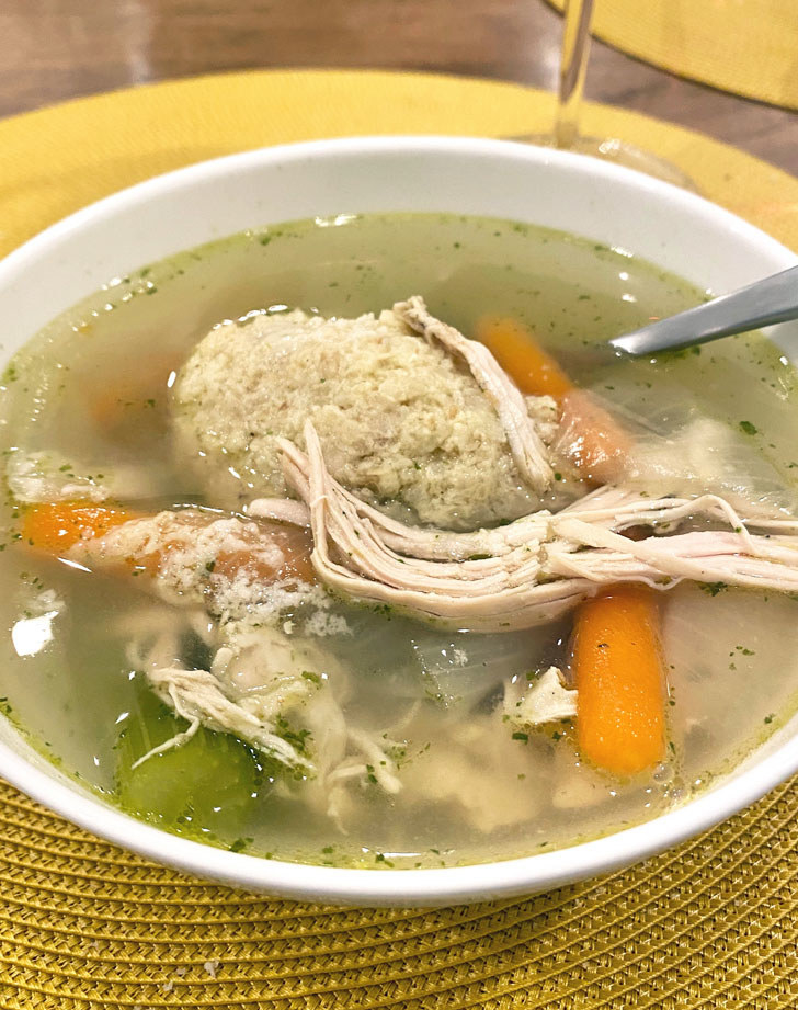 Matzo ball soup in a bowl.