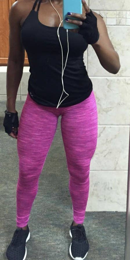 A reviewer standing in hot pink leggings