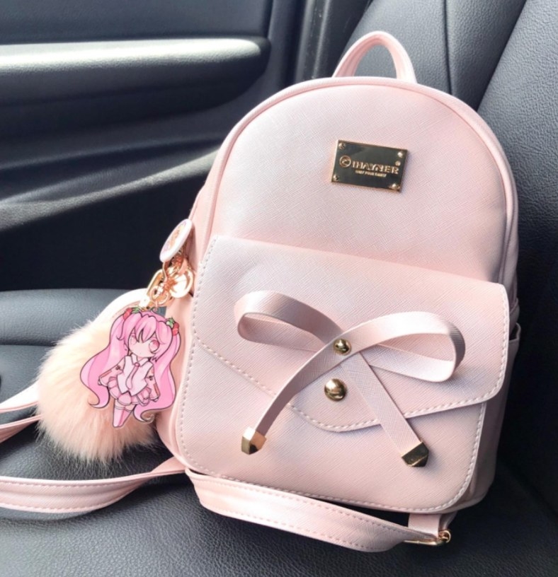 The backpack in pink in the passenger seat of a car 