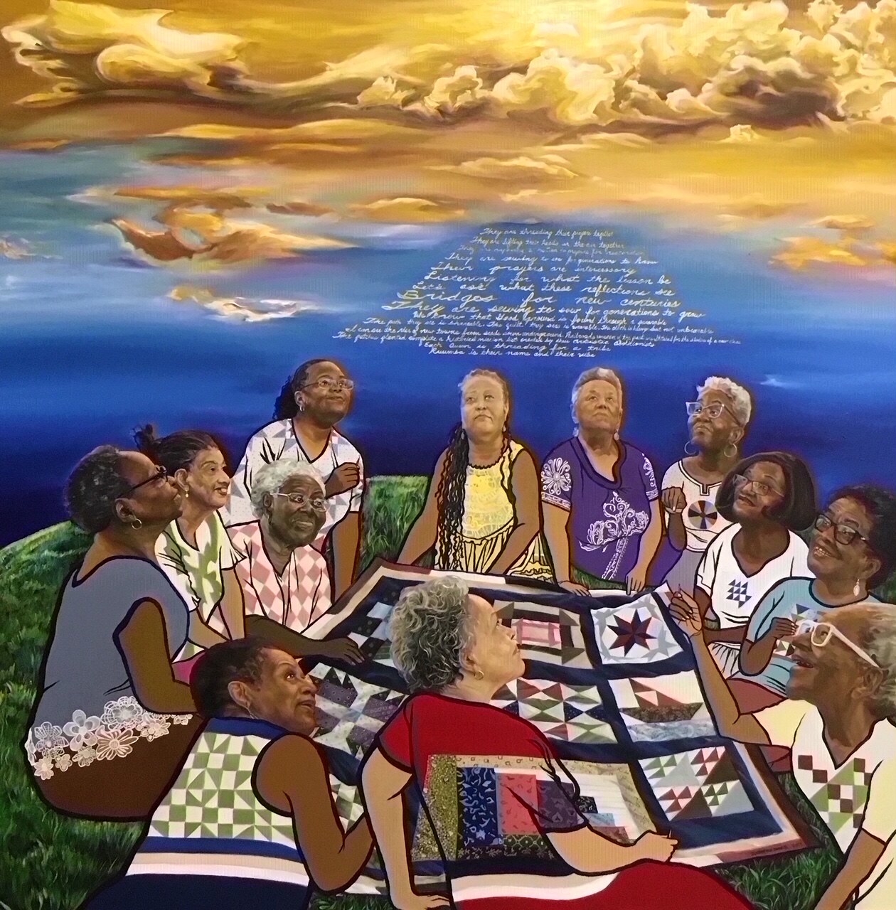 Painting of a group of women sitting around a quilt on the grass and looking up at sky filled with clouds and words