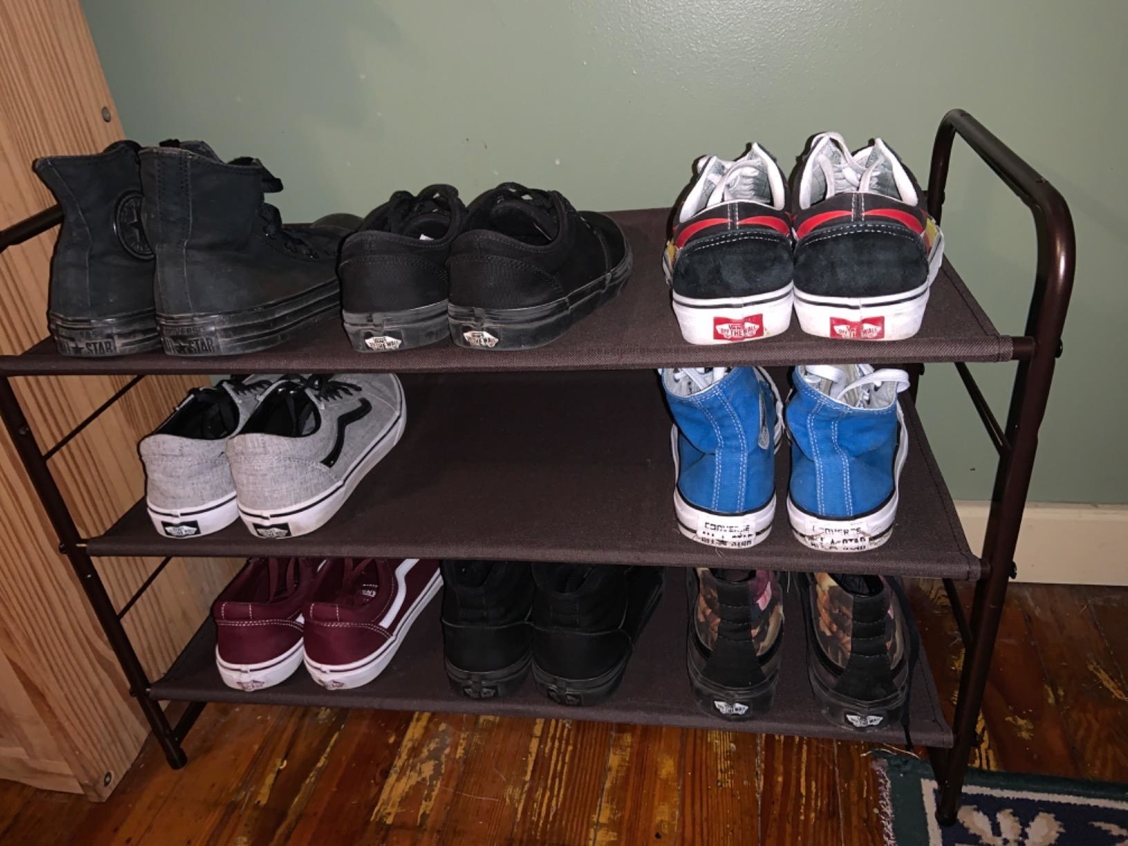 Reviewer photo of three-tier shoe rack with various shoes placed on the shelves