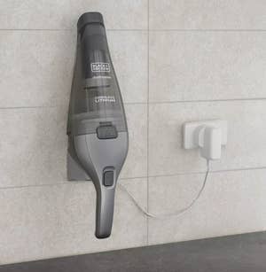 the handheld vacuum being charged 