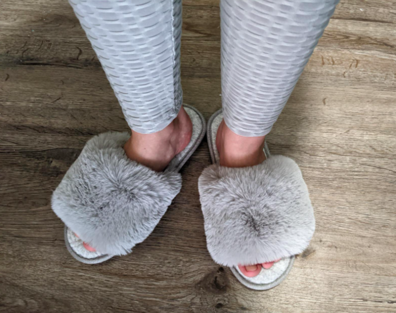 Reviewer wearing the fuzzy slippers