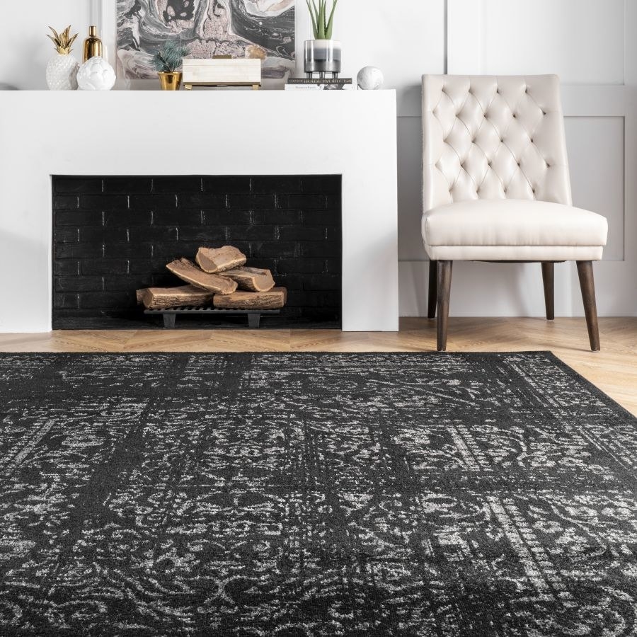 Black rug with faded gray Turkish rug pattern