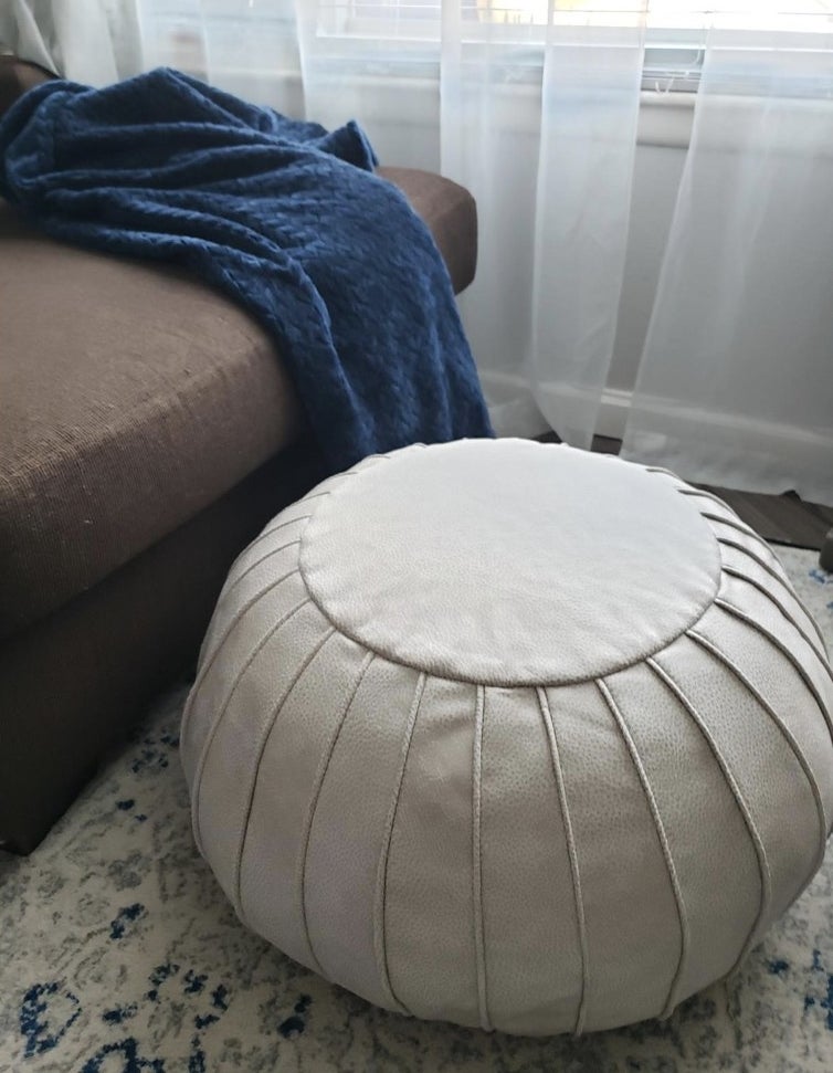 Reviewer&#x27;s photo of pouf sitting in living room 
