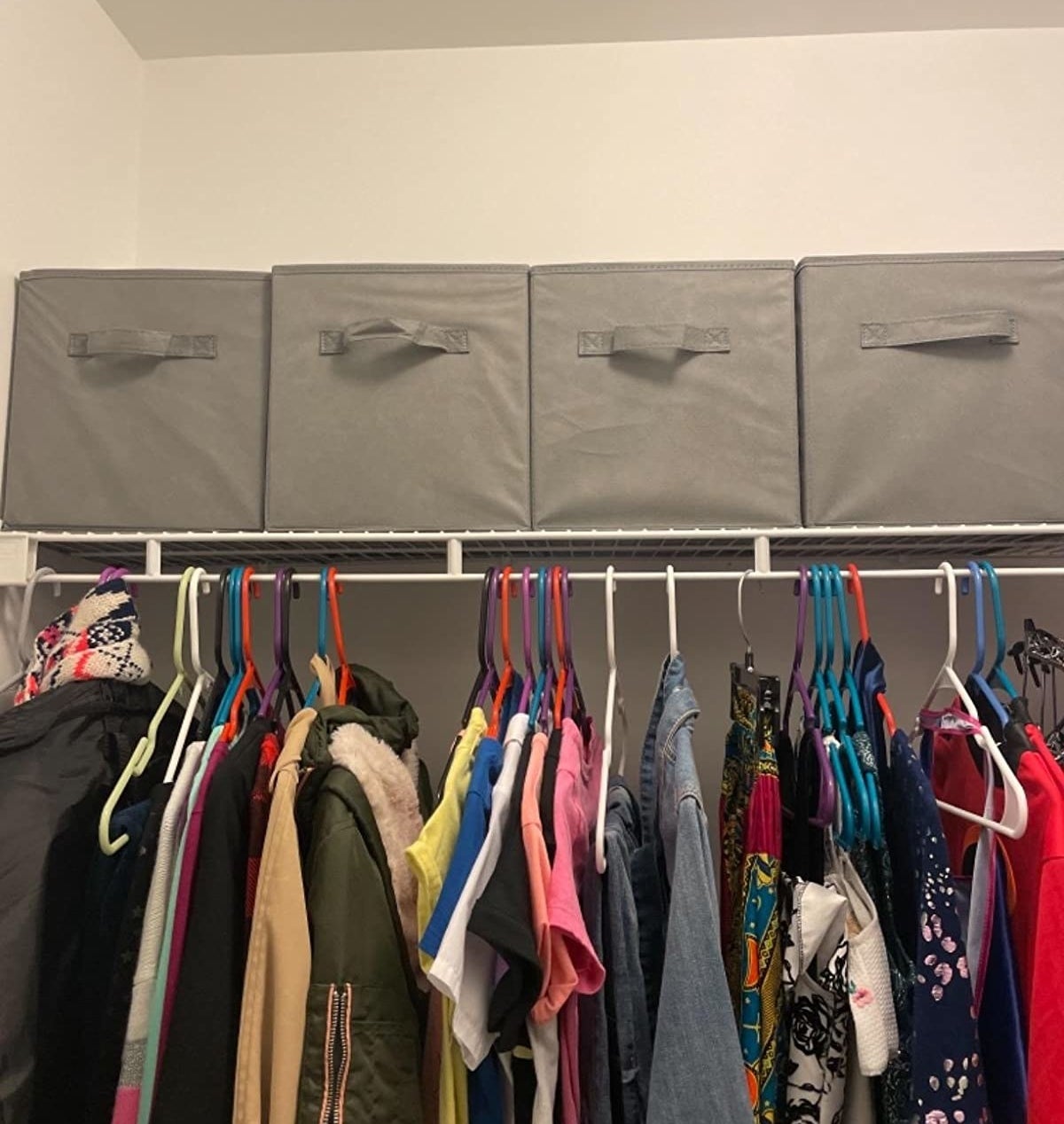 Reviewer photo of four storage cubes on closet shelf