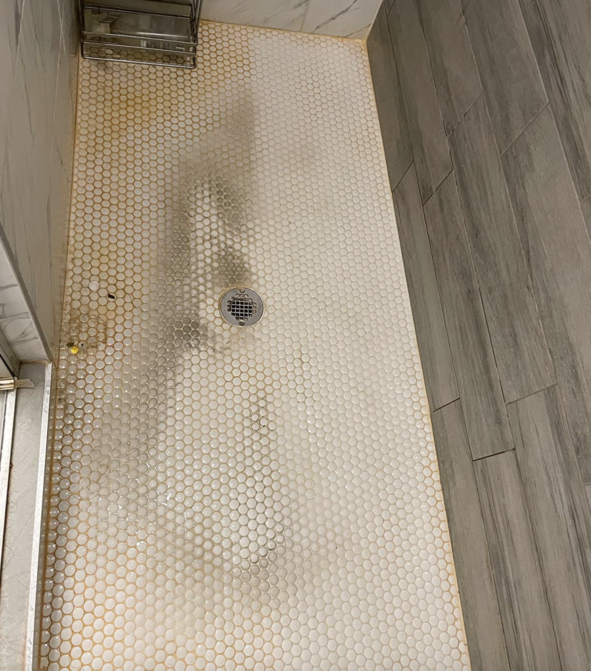 A customer review photo showing half their shower floor cleaned