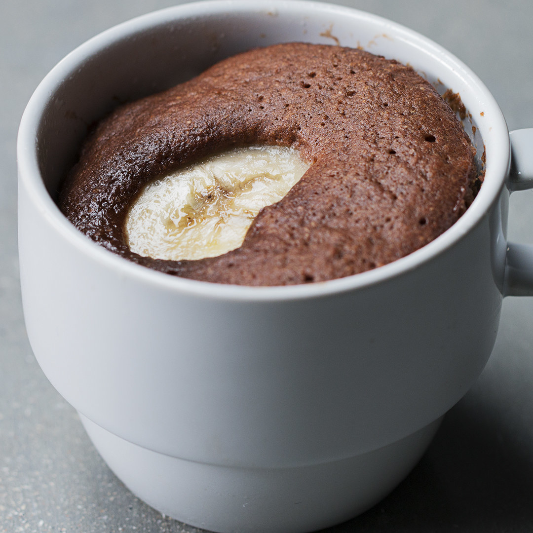 Chocolate cake with a cooked slice of banana on top 