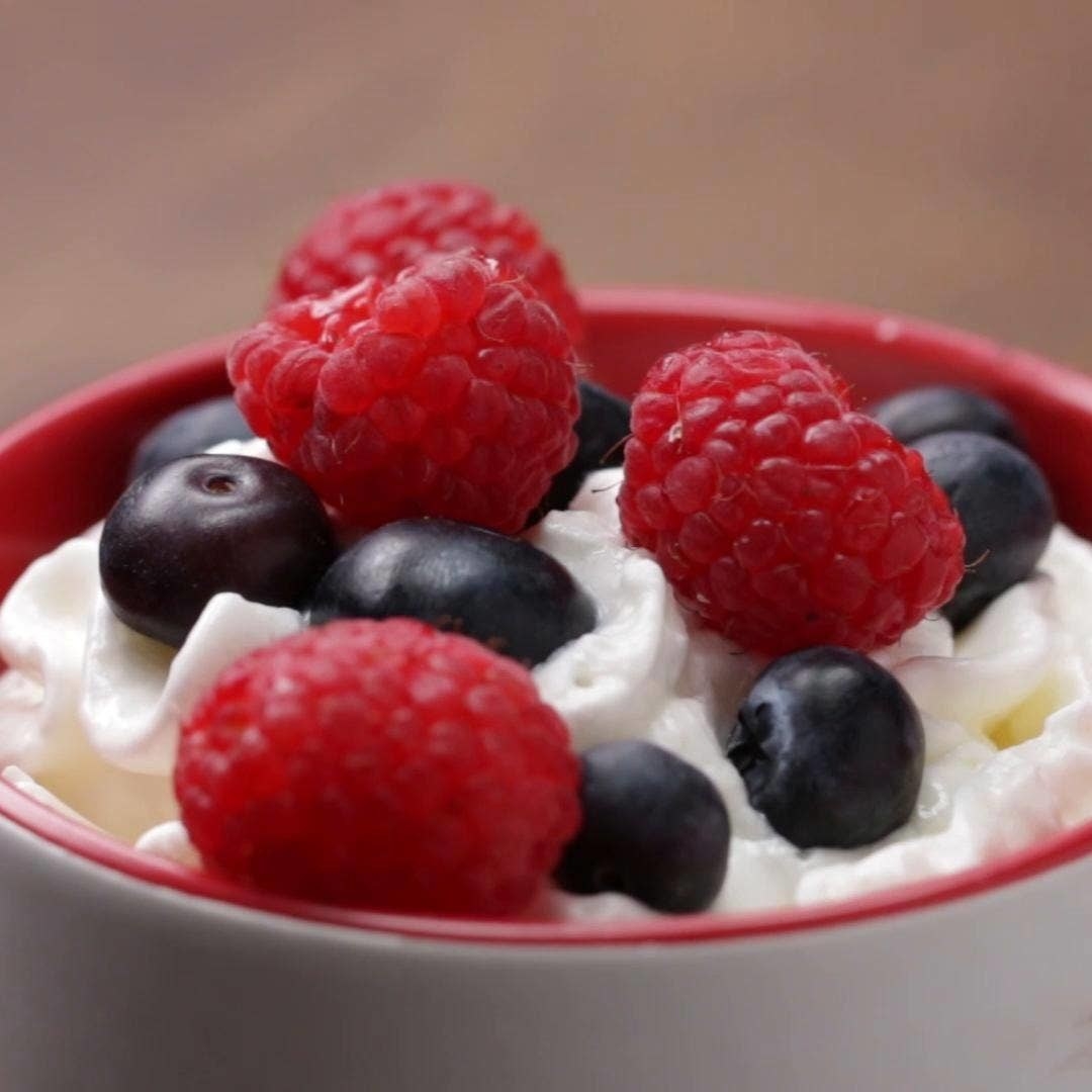 whip cream topped with raspberries, and blueberries