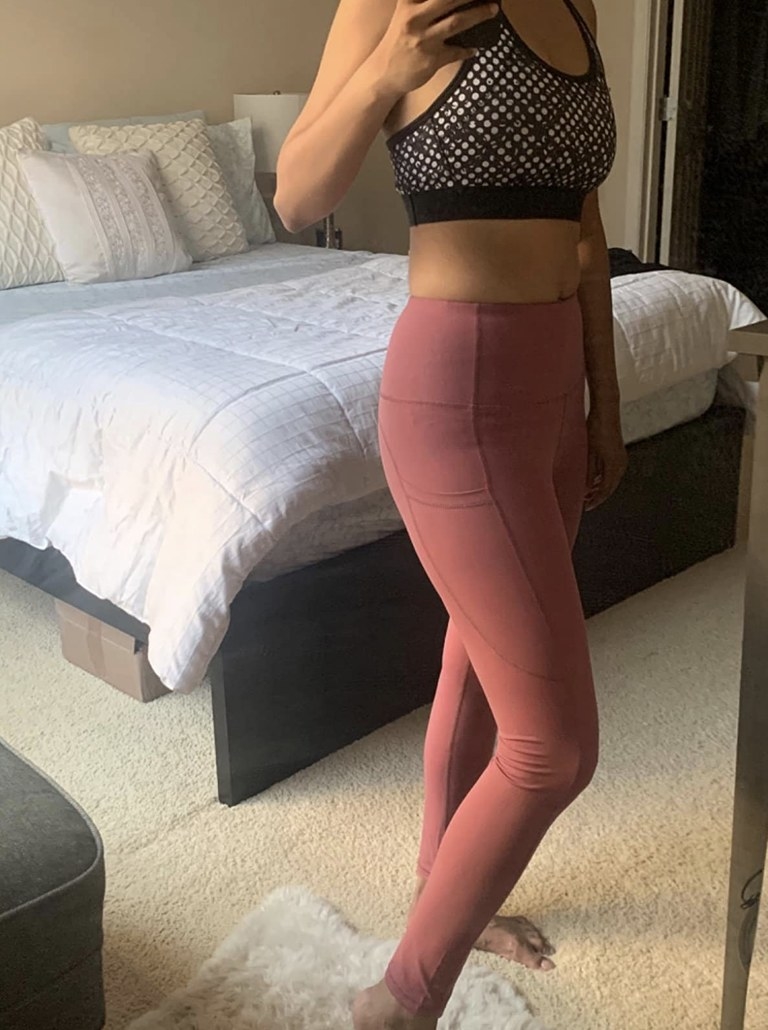 A girl wearing salmon colored leggings