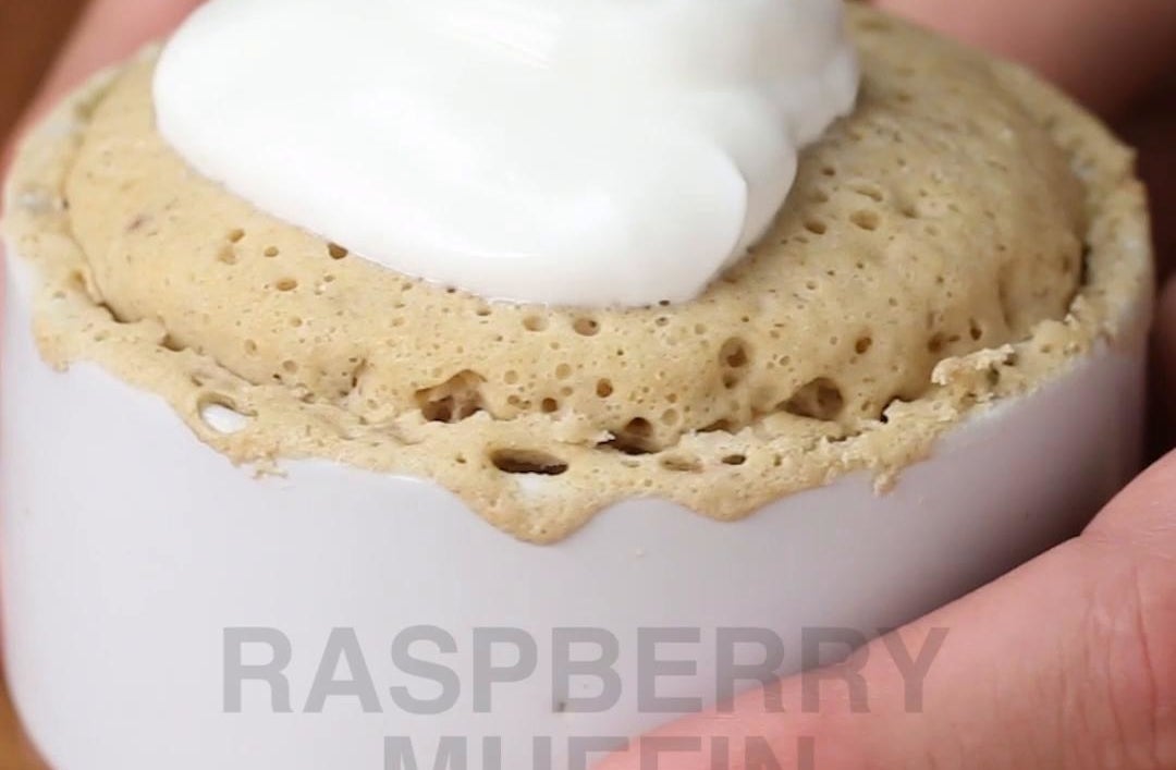 Cake topped with whip cream and raspberry jam