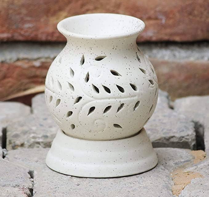 Ceramic aroma oil diffuser with leaf design.
