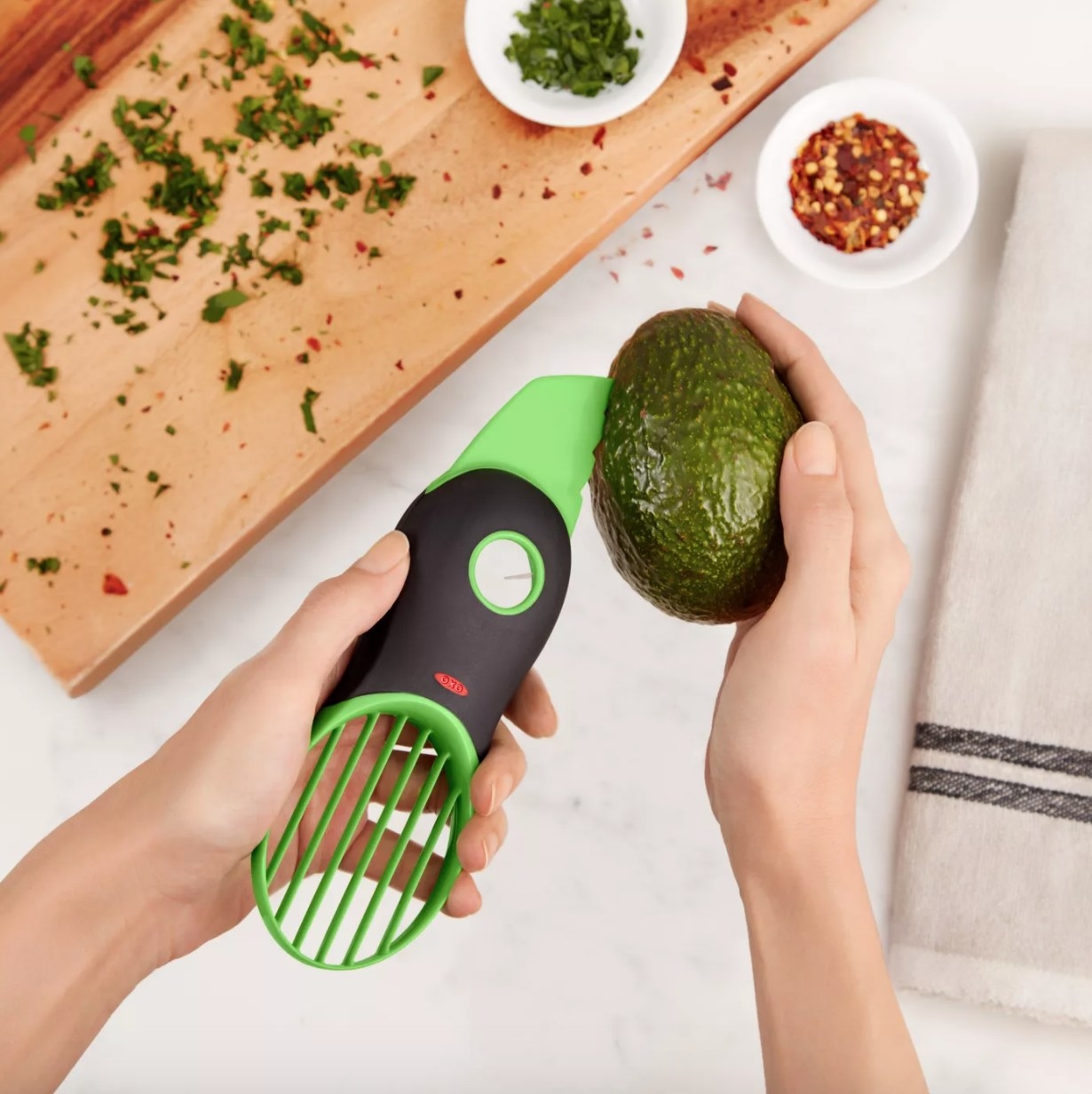 A green avocado slicer tool