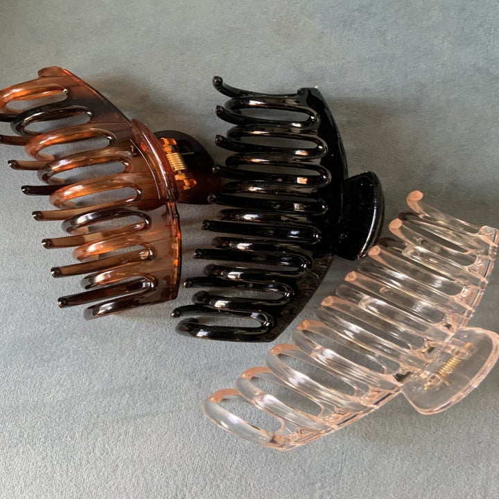 Three hair clips on a carpet