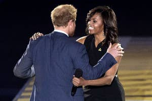 Michelle Obama hugs Prince Harry on a stage