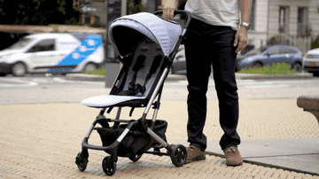 gif of person closing and collapsing the stroller with one hand