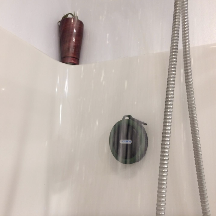 A customer review photo of their speaker in the shower under running water